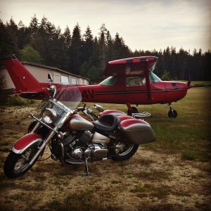 Motorcycle in front of airplane